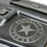 Close up image of Republic of Texas emblem engraved on silver gun