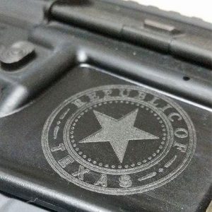 Close up image of Republic of Texas emblem engraved on silver gun