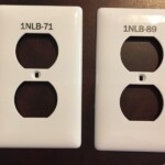 image of white engraved wall plug outlet electrical plates